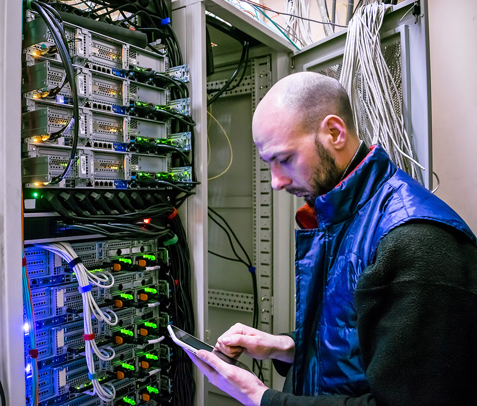 Telecom-engineer-with-servers2 Telecom-providers-engineer-with-servers